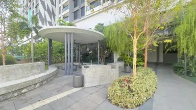 a building with a table and trees in a courtyard at KLCC View 1BR cozy suite with Balcony Trion B5310 KL in Kuala Lumpur