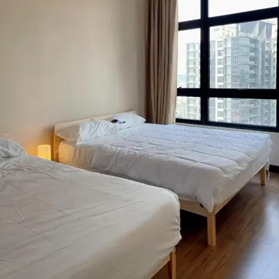two beds in a room with a large window at Astoria Ampang x Near KLCC TRX BigRoom 12pax in Kuala Lumpur