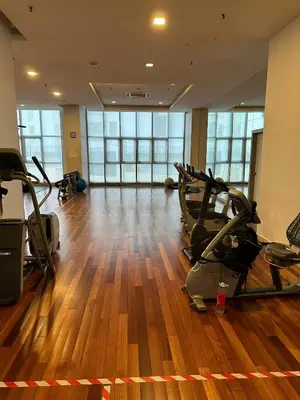 a gym with treadmills and exercise bikes in a room at Regalia Infinity Skypool in Kuala Lumpur