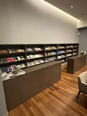 a waiting room with shelves of books at Regalia Infinity Skypool in Kuala Lumpur