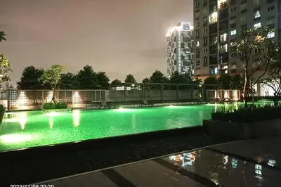 a swimming pool with lights in a city at night at Residensi Rampai 2 - lake view in setapak in Kuala Lumpur
