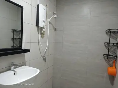 a white bathroom with a sink and a mirror at Residensi Rampai 2 - lake view in setapak in Kuala Lumpur