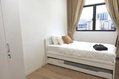a white bedroom with a bed with a window at Residensi Rampai 2 - lake view in setapak in Kuala Lumpur