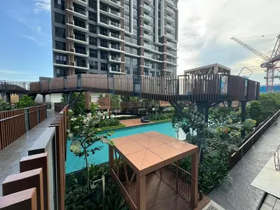 an elevated walkway over a pool with a table and a building at TRION 2, KLCC TRX IKEA at Chan Sow Lin, Kuala Lumpur by One Guesthouse in Kuala Lumpur