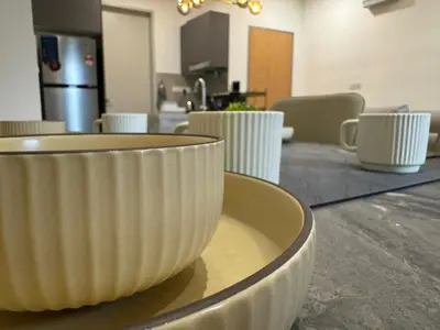 a table with white cups sitting on top of it at TRION 2, KLCC TRX IKEA at Chan Sow Lin, Kuala Lumpur by One Guesthouse in Kuala Lumpur
