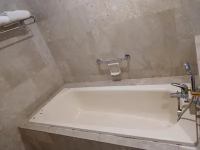 a bath tub in a bathroom with a sink at Gorgeous service suite at Imbi in Kuala Lumpur