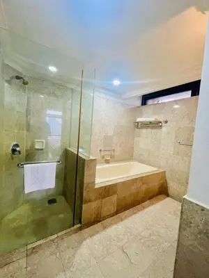 a bathroom with a shower and a tub and a sink at Gorgeous service suite at Imbi in Kuala Lumpur