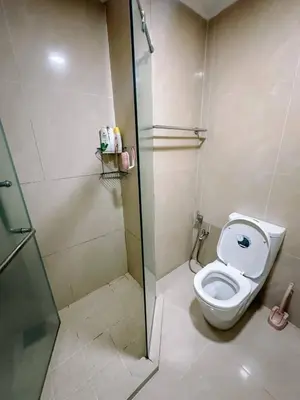 a bathroom with a toilet and a glass shower stall at Parkview KLCC ITSKAYA 21 NEW in Kuala Lumpur