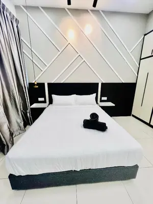a bedroom with a bed with a black hat on it at Chambers Residence KLCC in Kuala Lumpur
