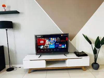 a flat screen tv sitting on top of a white cabinet at Chambers Residence KLCC in Kuala Lumpur
