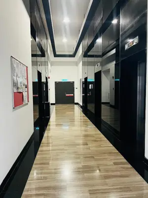 a hallway of an office with black walls and wooden floors at Chambers Residence KLCC in Kuala Lumpur