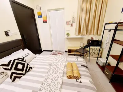 a bedroom with a large bed with pillows on it at Mini Studio Near Gleneagles 10 mins to KLCC in Kuala Lumpur