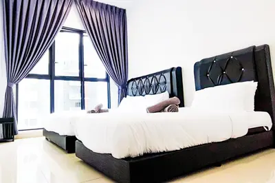 a bedroom with two beds and a large window at KL City View at Trion 2 by HCK in Kuala Lumpur