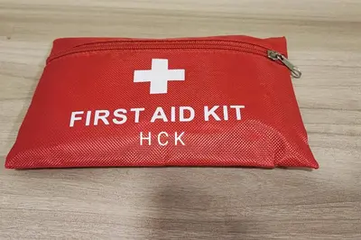 a red first aid kit with the words first aid kit at KL City View at Trion 2 by HCK in Kuala Lumpur