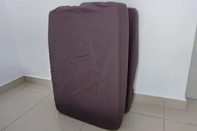 a purple suitcase sitting on the floor next to a wall at KL City View at Trion 2 by HCK in Kuala Lumpur