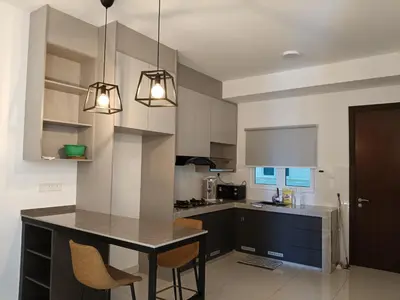 a kitchen with a table and chairs in it at 2BR Centre MontKiara 4px 500Mbps in Kuala Lumpur