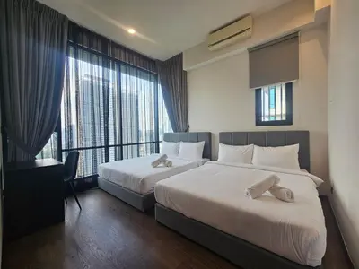 a hotel room with two beds and a large window at Opus Residences by Star Haven in Kuala Lumpur