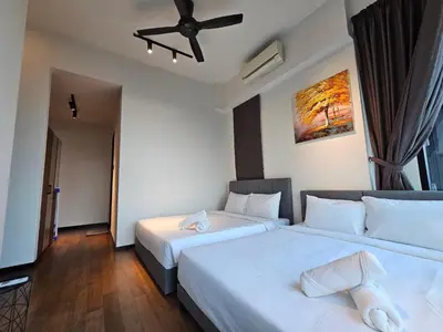 a bedroom with two beds and a ceiling fan at Opus Residences by Star Haven in Kuala Lumpur