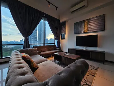 a living room with a couch and a flat screen tv at Opus Residences by Star Haven in Kuala Lumpur