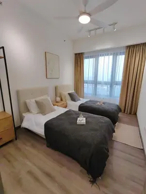 a bedroom with two beds and a large window at Agile Bukit Bintang KLCC in Kuala Lumpur