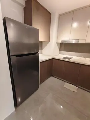 a kitchen with a stainless steel refrigerator at Agile Bukit Bintang KLCC in Kuala Lumpur