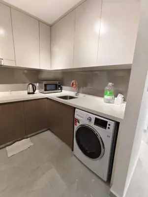 a kitchen with a washing machine and a sink at Agile Bukit Bintang KLCC in Kuala Lumpur