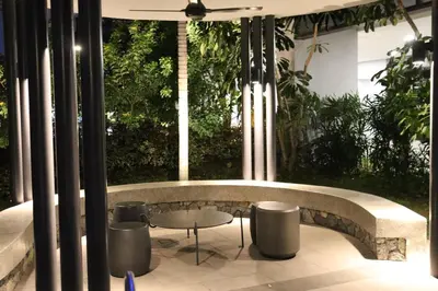 a patio with a table and stools in front of a window at Trion SFM Dream Service suit in Kuala Lumpur