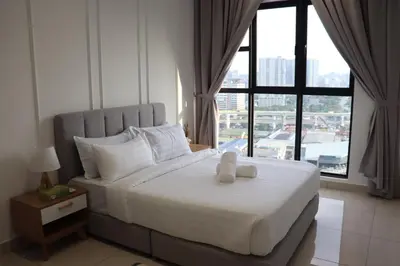 a white teddy bear sitting on a bed in a bedroom at Trion SFM Dream Service suit in Kuala Lumpur