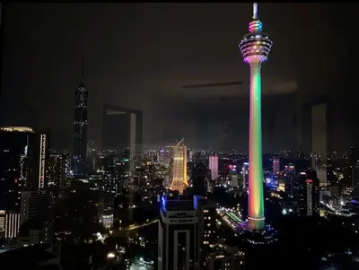 a view of the space needle lit up at night at vortex suites klcc by twin tower vibes in Kuala Lumpur