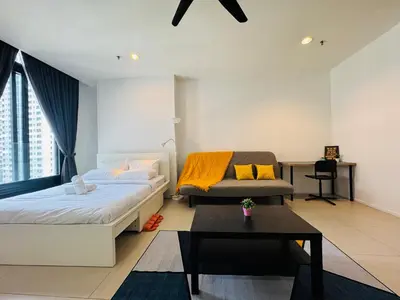 a bedroom with a bed and a table in it at Arcoris Residence Mont Kiara by DeUrban in Kuala Lumpur