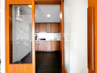 a kitchen with wooden cabinets and a counter top at Una Serviced Apartment by Manhattan Group in Kuala Lumpur