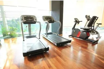 three exercise bikes in a gym with a wooden floor at 0203 Sweet Home-Casa Residency 2R 2B City View in Kuala Lumpur
