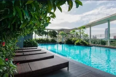 a swimming pool with benches in a building at 0203 Sweet Home-Casa Residency 2R 2B City View in Kuala Lumpur