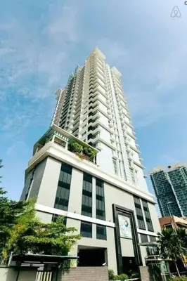 a tall white building with a clock on it at 0203s Sweet Home-Casa Residency in Kuala Lumpur