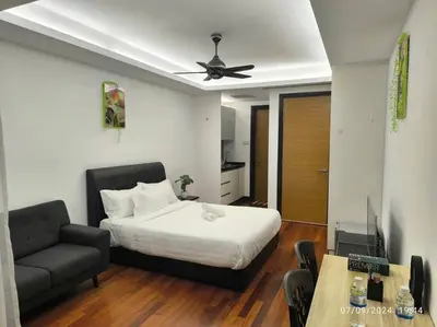 a bedroom with a bed and a couch and a television at 0203s Sweet Home-Casa Residency in Kuala Lumpur