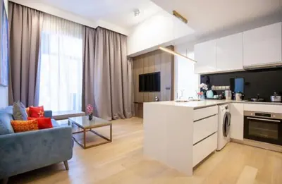 a kitchen and living room with a couch and a table at Star Luxury By Star Residences KLCC in Kuala Lumpur