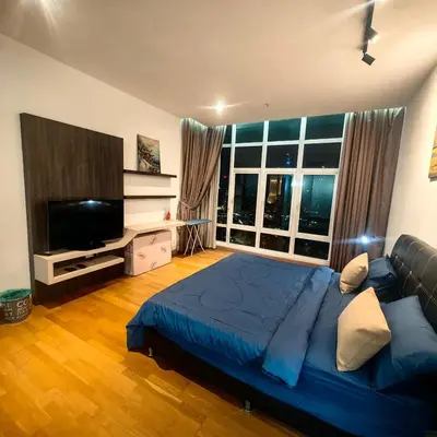 a bedroom with a large bed and a flat screen tv at KL Sentral Dua Sentral King Bedroom Suite With Merdeka 118 and KLCC View #FreeParking in Kuala Lumpur