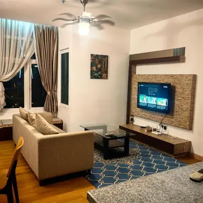a living room with a couch and a tv at KL Sentral Dua Sentral King Bedroom Suite With Merdeka 118 and KLCC View #FreeParking in Kuala Lumpur