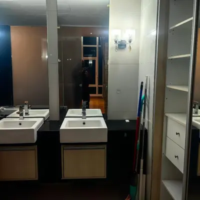 a person taking a picture of a bathroom with two sinks at KL Sentral Dua Sentral King Bedroom Suite With Merdeka 118 and KLCC View #FreeParking in Kuala Lumpur