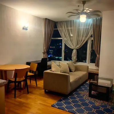 a living room with a couch and a table at KL Sentral Dua Sentral King Bedroom Suite With Merdeka 118 and KLCC View #FreeParking in Kuala Lumpur