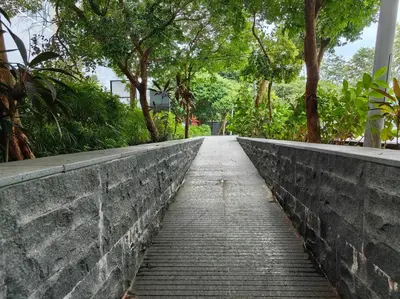 a brick path with trees on the side of a wall at 8 KLCC 5 minutes to Jalan Alor Street Bukit Bintang Pavilion 10 Pax 3R2B in Kuala Lumpur