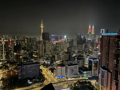 a view of a city at night with at 1BR condo with Amazing KLCC View & Infinity Pool at Lalaport Bukit Bintang in Kuala Lumpur