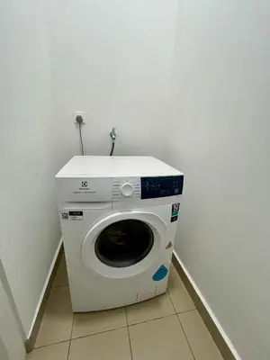 a washing machine in a corner of a room at KL Central 31st floor KLCC view in Kuala Lumpur