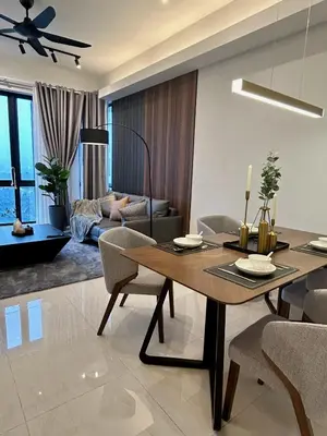 a dining room and living room with a table and chairs at KL Central 31st floor KLCC view in Kuala Lumpur
