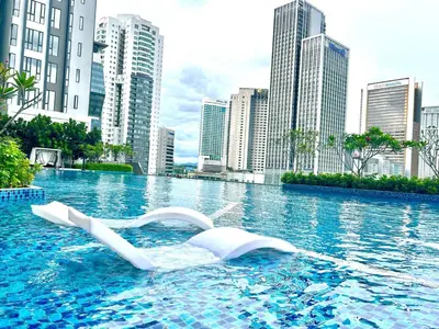 a swimming pool in a city with tall buildings at KL Central 31st floor KLCC view in Kuala Lumpur