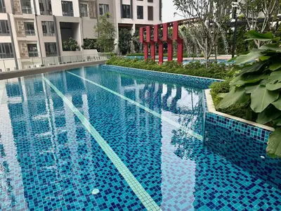 a large blue swimming pool with a building at KL Central 31st floor KLCC view in Kuala Lumpur