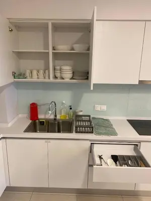 a kitchen with white cabinets and a sink at KL Central 33rd Floor KLCC view in Kuala Lumpur