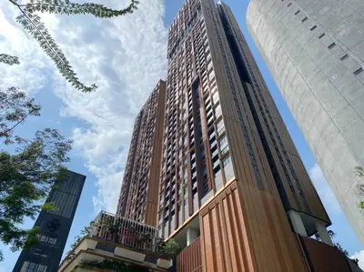 a tall building in the middle of two buildings at Studio with Amazing KLCC View & Infinity Pool at Lalaport Bukit Bintang in Kuala Lumpur