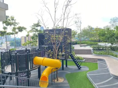 a playground with a yellow slide in a park at Studio with Amazing KLCC View & Infinity Pool at Lalaport Bukit Bintang in Kuala Lumpur