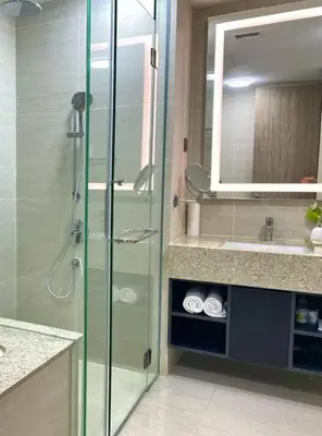 a bathroom with a glass shower and a sink at Star Xtian Residence KLCC in Kuala Lumpur